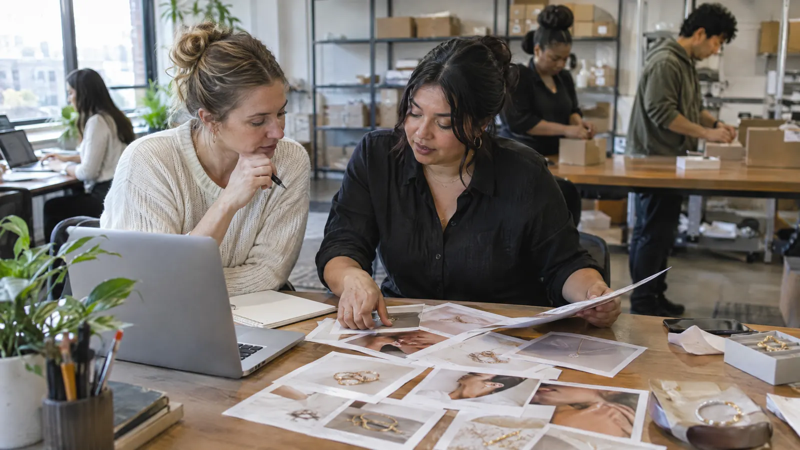 A jewelry retailer's team reviewing product photos
