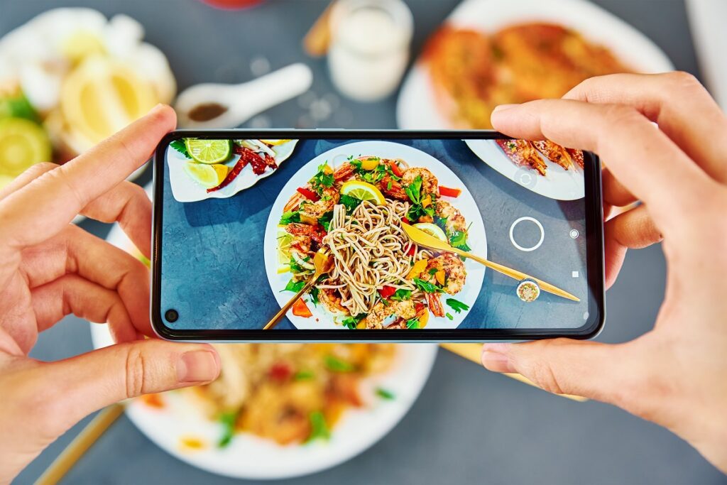 taking photo of stir fry noodle with smartphone